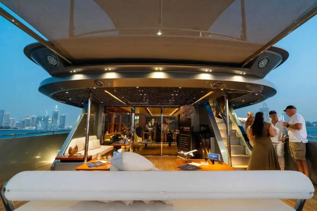 Santorini superyacht at dusk with RightJet branding and Dubai skyline during CJI Dubai 2026