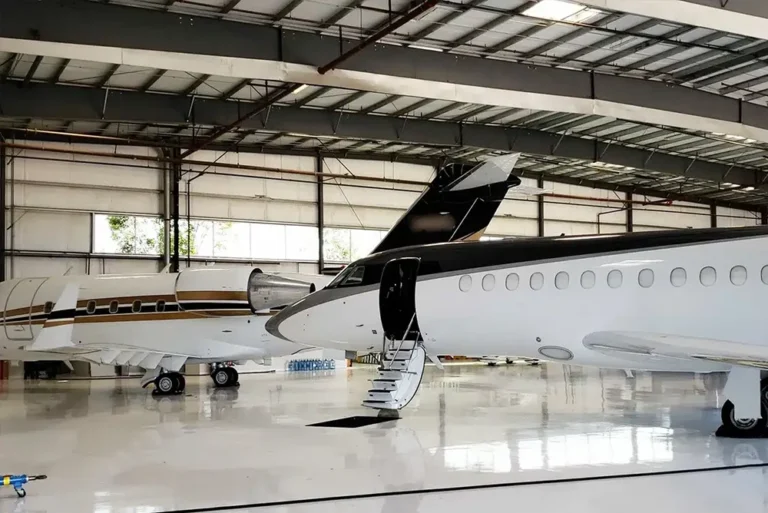 Private jets in a well maintained hangar under aircraft management in UAE
