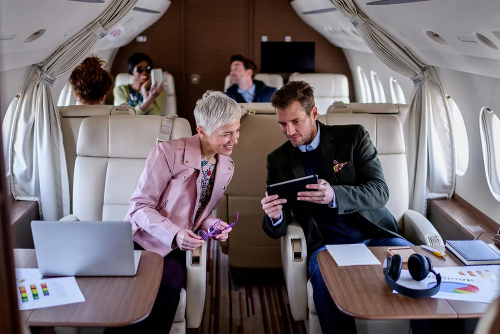 Business travellers onboard a private jet during a charter flight